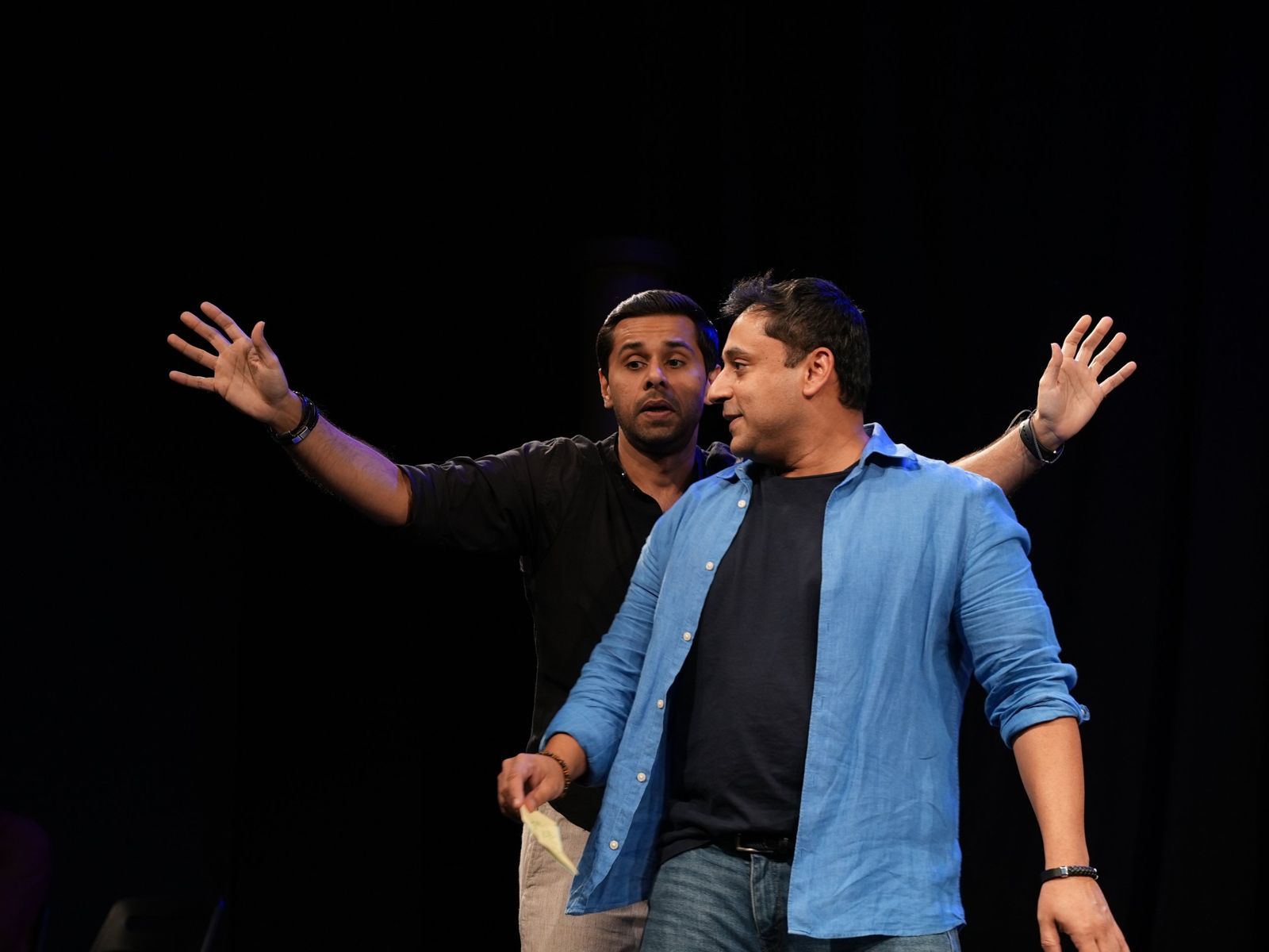 Two performers building a scene together
